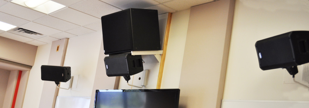 Front wall speakers on a 5.1 surround system in a music classroom.